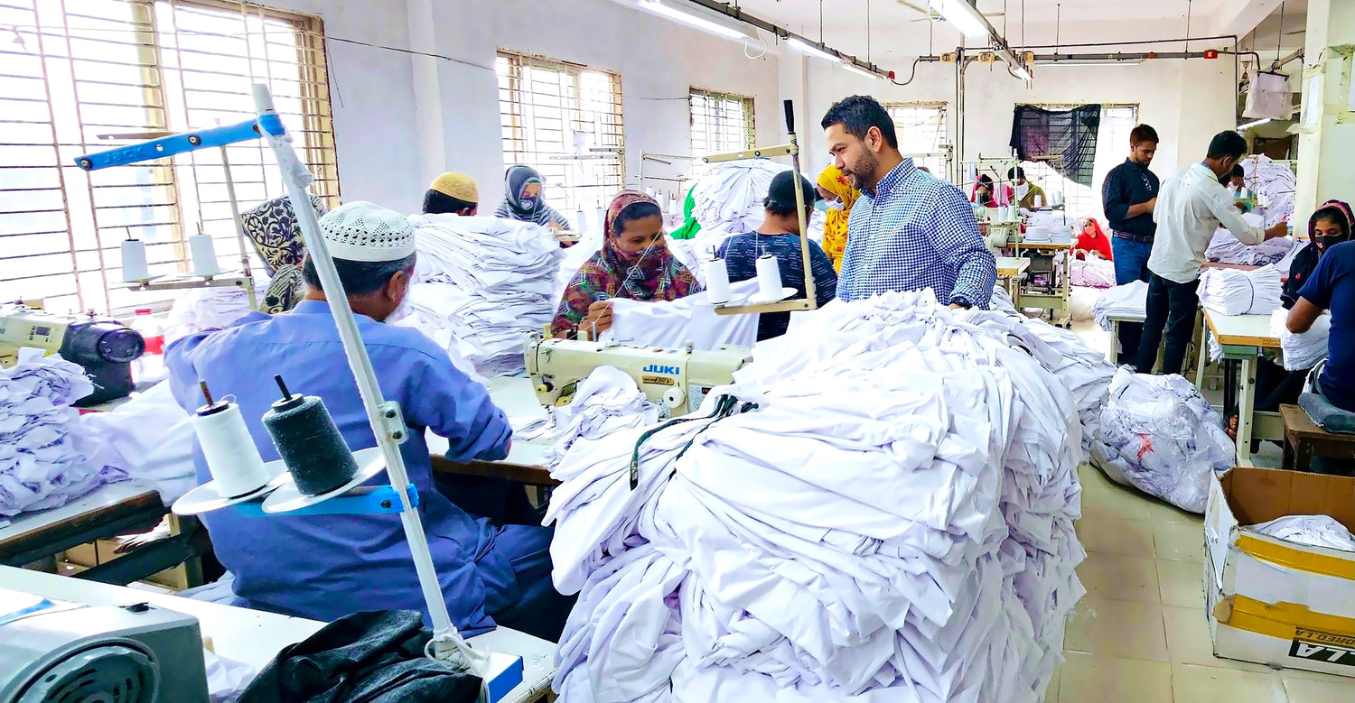 MMS fashion agency owner overseeing garment production at a textile facility.